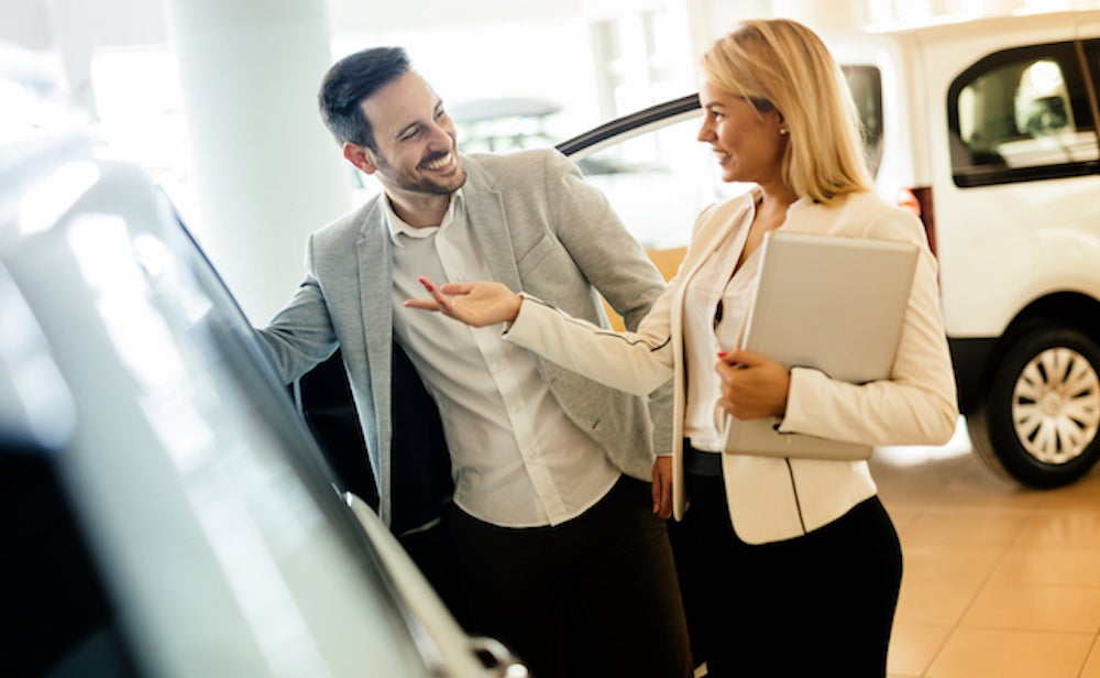 How to Sell My Electric Vehicle Dealership Salesman speaking with customer